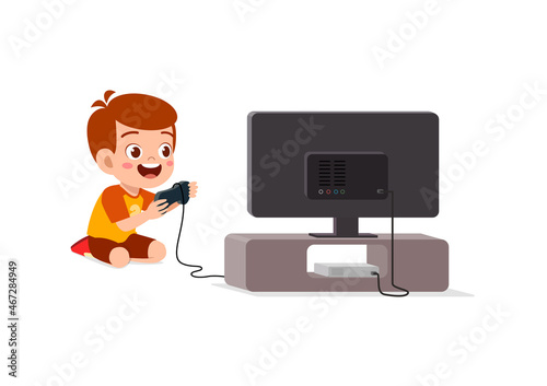 cute little boy play video game on big screen