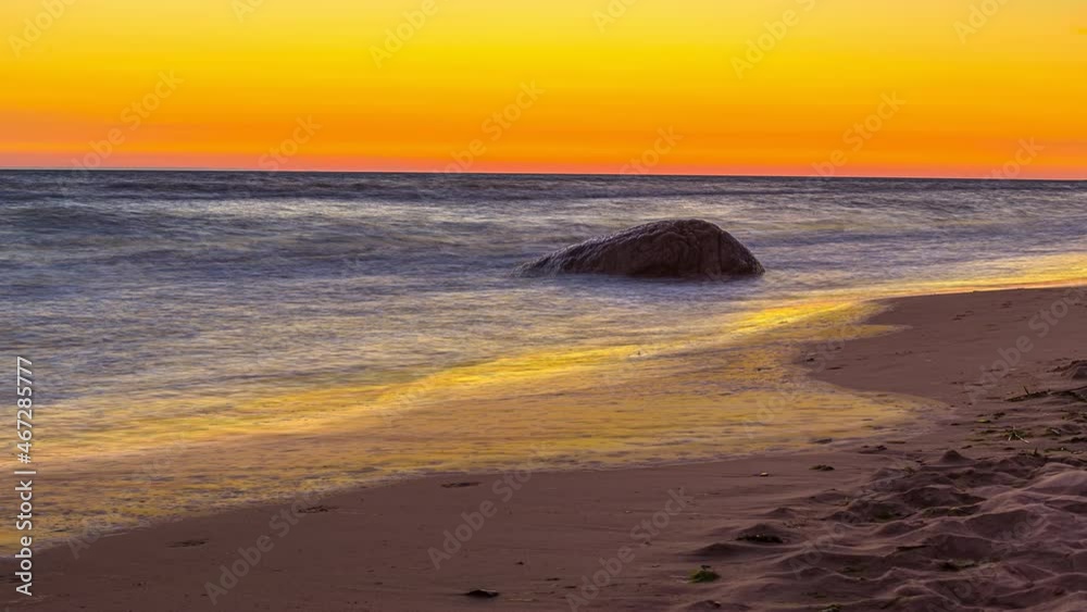 Perfect beach timelapse with tide going up and down with yellow and orange sky Perfect beach timelapse with tide going up and down with yellow and orange sky