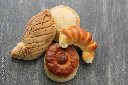 Sweet bread: Bisquet, croissant, Ojo de Pancha and Gusano freshly made from Mexican cuisine in a basket, or napkin accompanied by coffee
