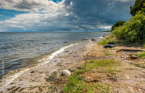 Sandy beach of the Baltic Sea and approaching thunderstorm photo