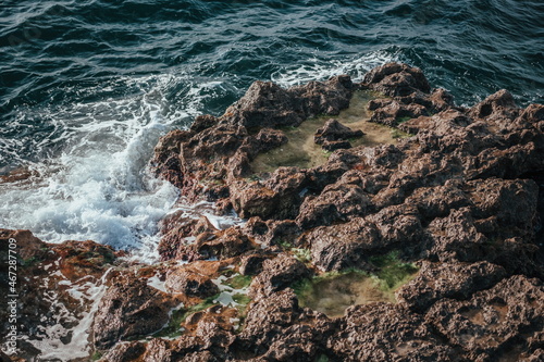 A rock near blue green clear ocean sea water. holidays and weekend vacation in summer time.