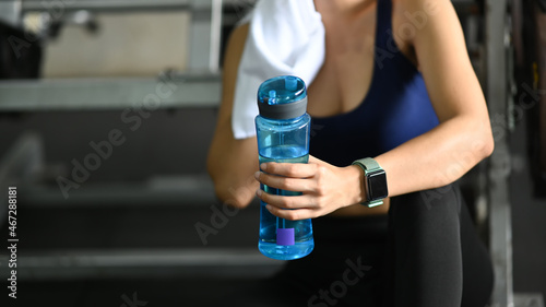 Sport woman resting after workout in fitness gym.