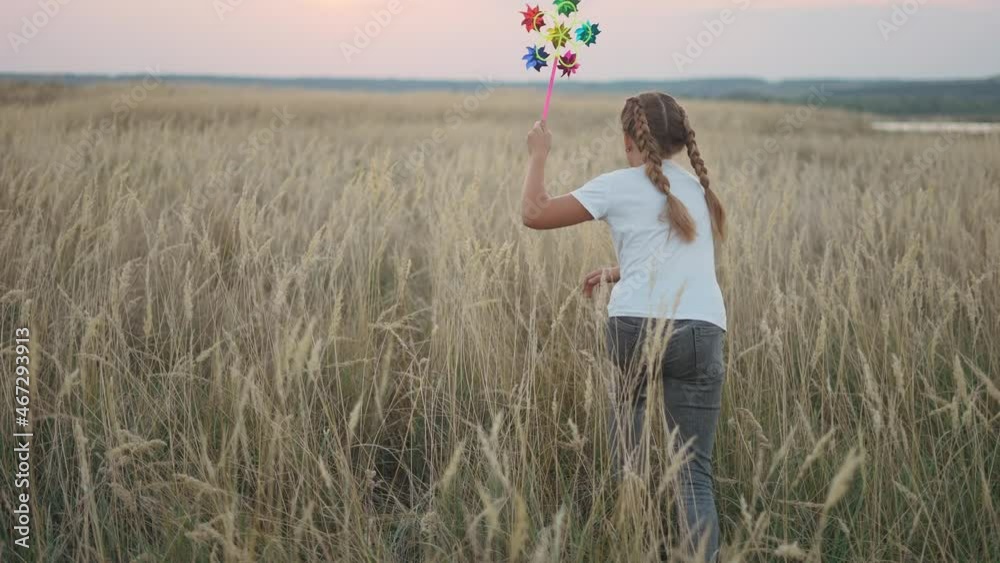 little girl run with a wind toy pinwheel. happy family kid dream concept. girl child run plays outdoors in the park. with a wind pinwheel toy. happy lifestyle family childhood concept little girl run with a wind toy pinwheel. happy family kid dream concept. girl child run plays outdoors in the park. with a wind pinwheel toy. happy lifestyle family childhood concept