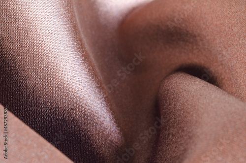 Brown satin fabric. Close-up. Chocolate Background