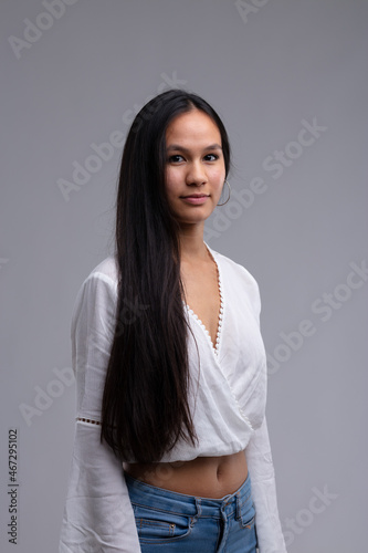 Attractive slender young woman with long straight dark hair