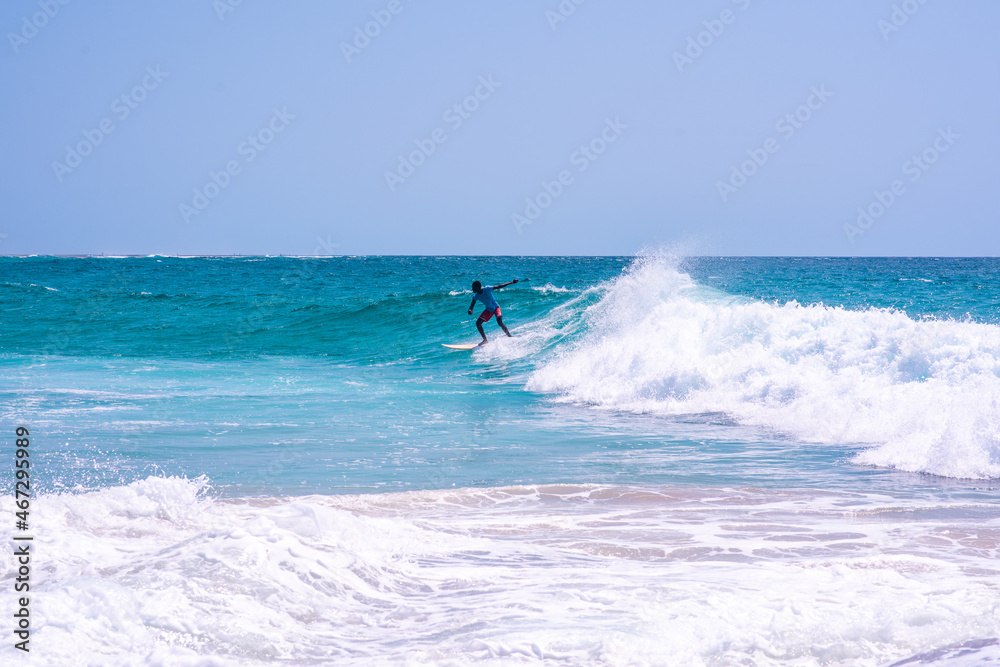 Young man seen riding wave with his surfboard Young man seen riding wave with his surfboard