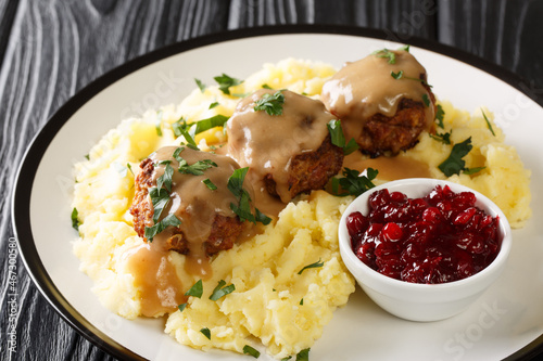 Bilde på lerret Tasty Meatballs with gravy, mashed potatoes and lingonberry jam close-up in a plate on the table
