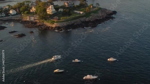 Yachts anchored and sailing near a rocky shore in Marblehead Peninsula photo