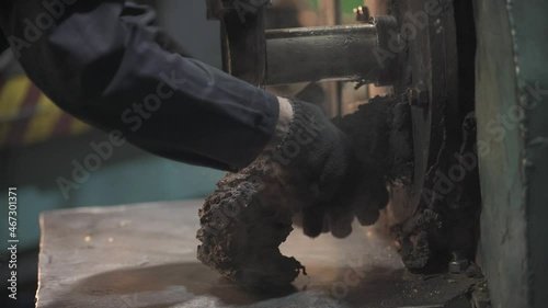 melting plastic at the factory and laying in the conductor under the press photo