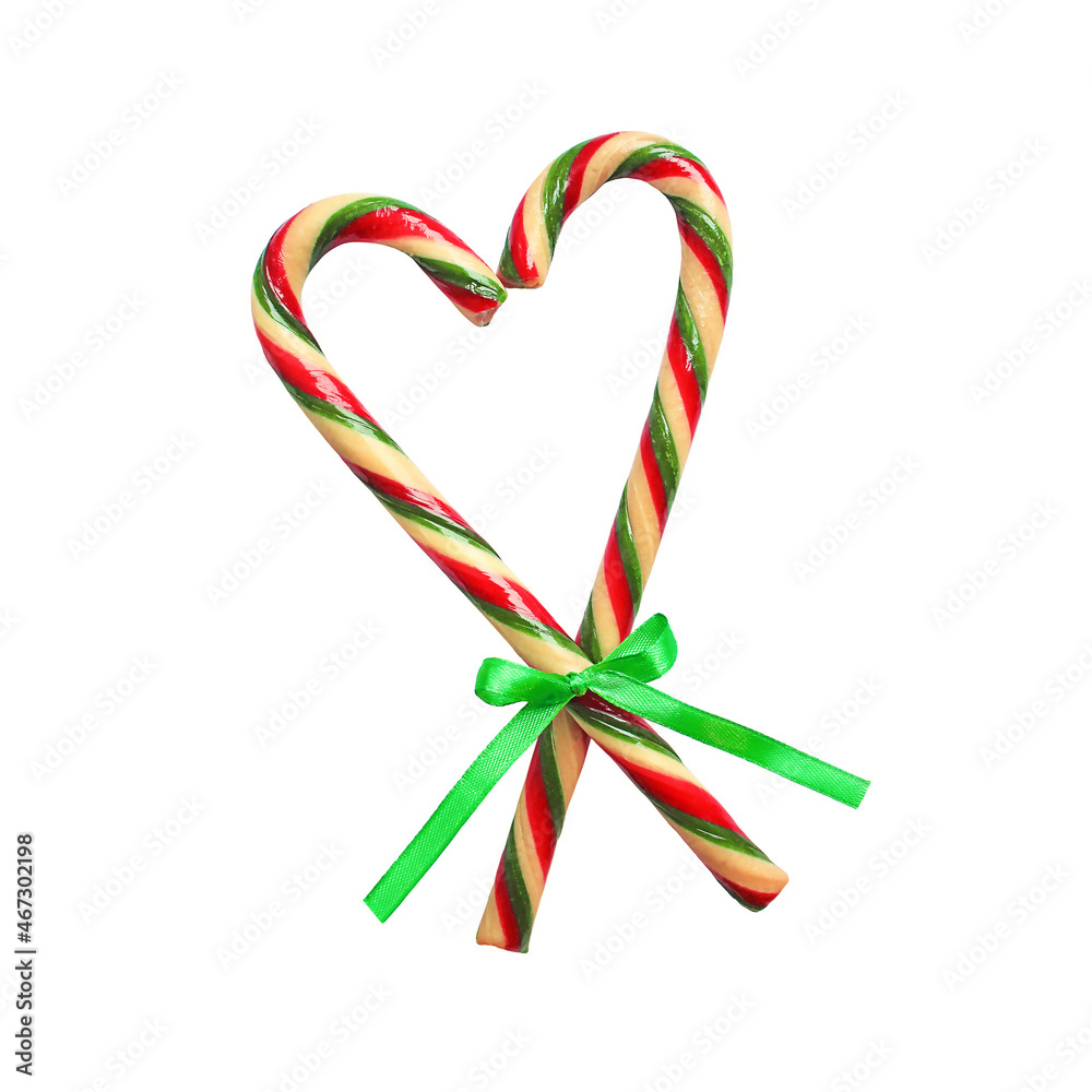 Christmas candy cane heart isolated on white. New Year Christmas decoration candy canes ribbon with bow.