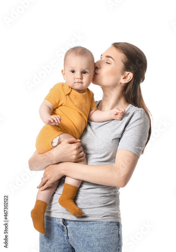 Young mother kissing little...