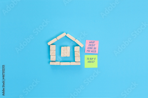 A small house made of wooden blocks and  sticky notes