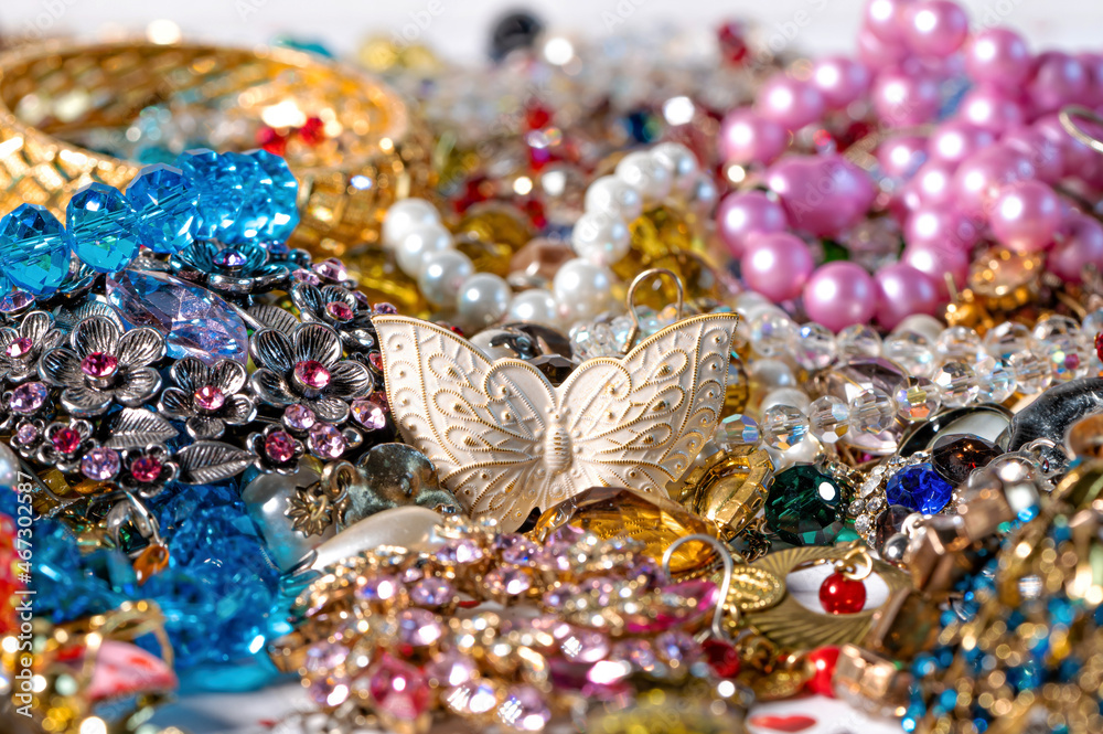 necklaces, earrings, bracelets, pearls, beads and various colored gemstones as a background necklaces, earrings, bracelets, pearls, beads and various colored gemstones as a background