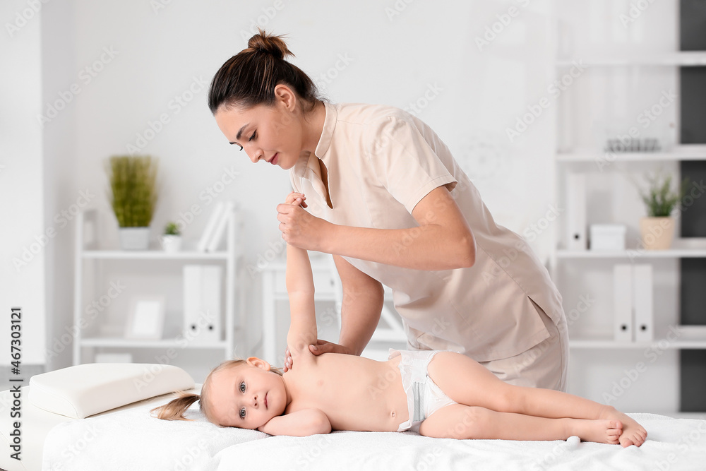 Massage therapist working with baby in medical center Massage therapist working with baby in medical center