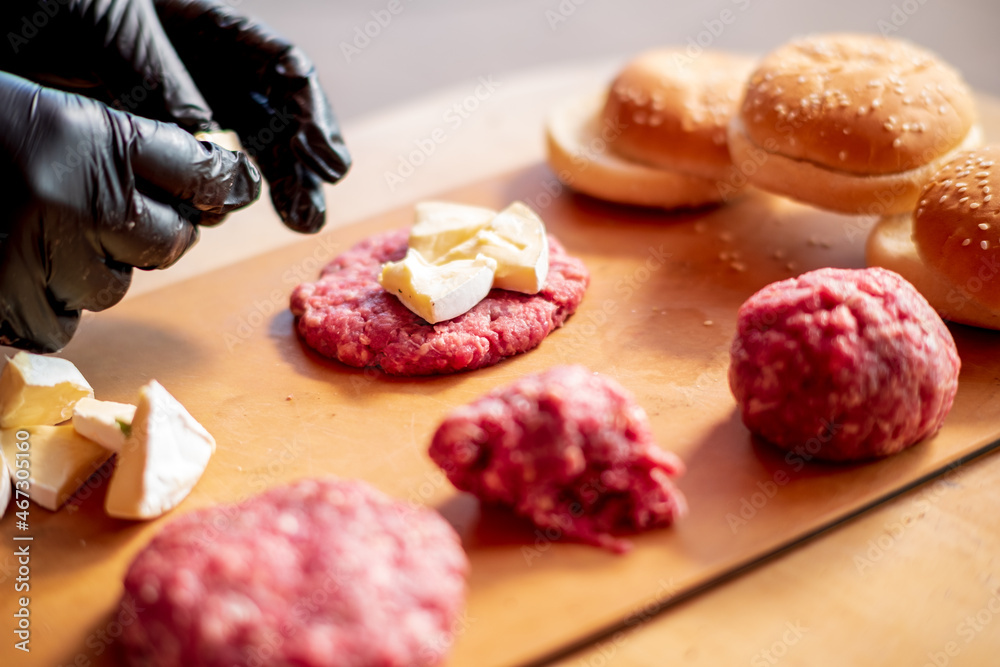 Male chef cook preparing homemade burger. Male chef cook preparing homemade burger.