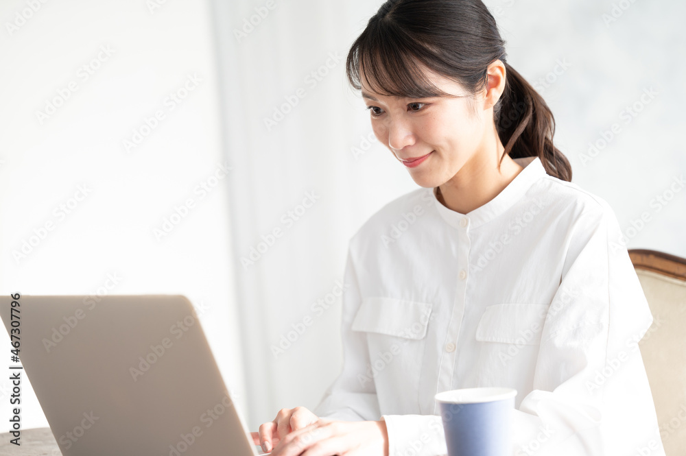 Beautiful Asian woman working on computer with her head down Beautiful Asian woman working on computer with her head down