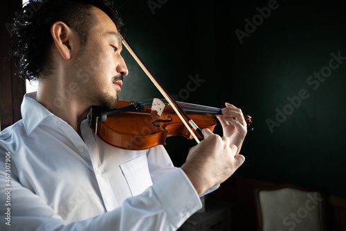 The image of a handsome violinist that could be used for concerts close-up photo