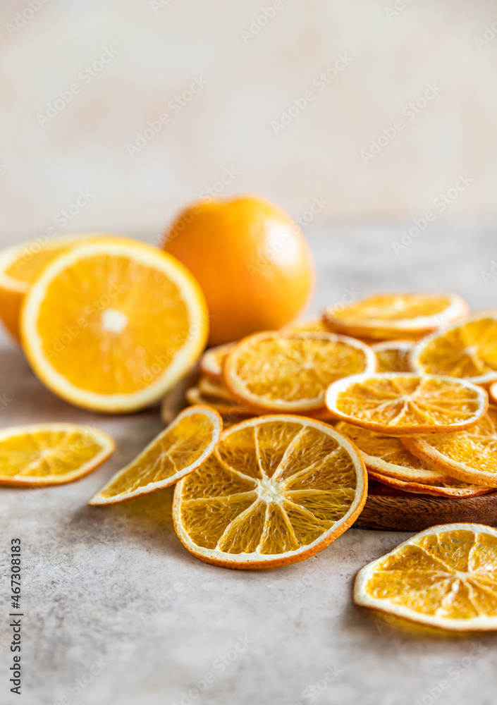 Natural dried oranges on light concrete background. Sliced and dried citrus fruit. Natural dried oranges on light concrete background. Sliced and dried citrus fruit.