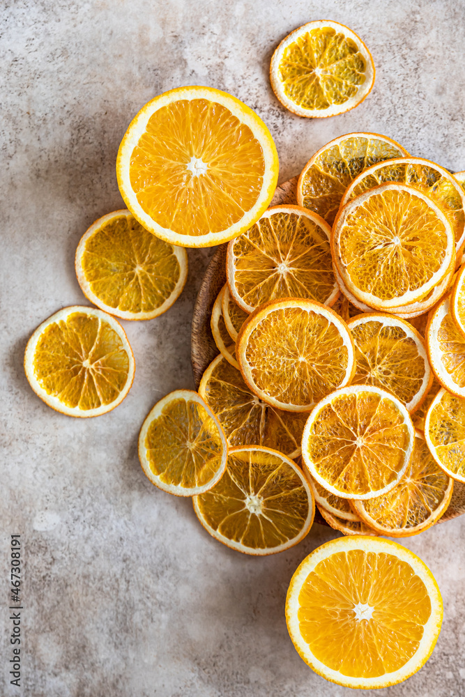 Natural dried oranges on light concrete background. Sliced and dried citrus fruit. Natural dried oranges on light concrete background. Sliced and dried citrus fruit.