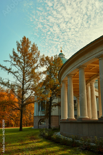Part of Temple-tomb of the Yusupovs Colonnade in Arkhangelskoye Palace near Moscow. View on mausoleum Colonnade and colorful trees with orange foliage. photo