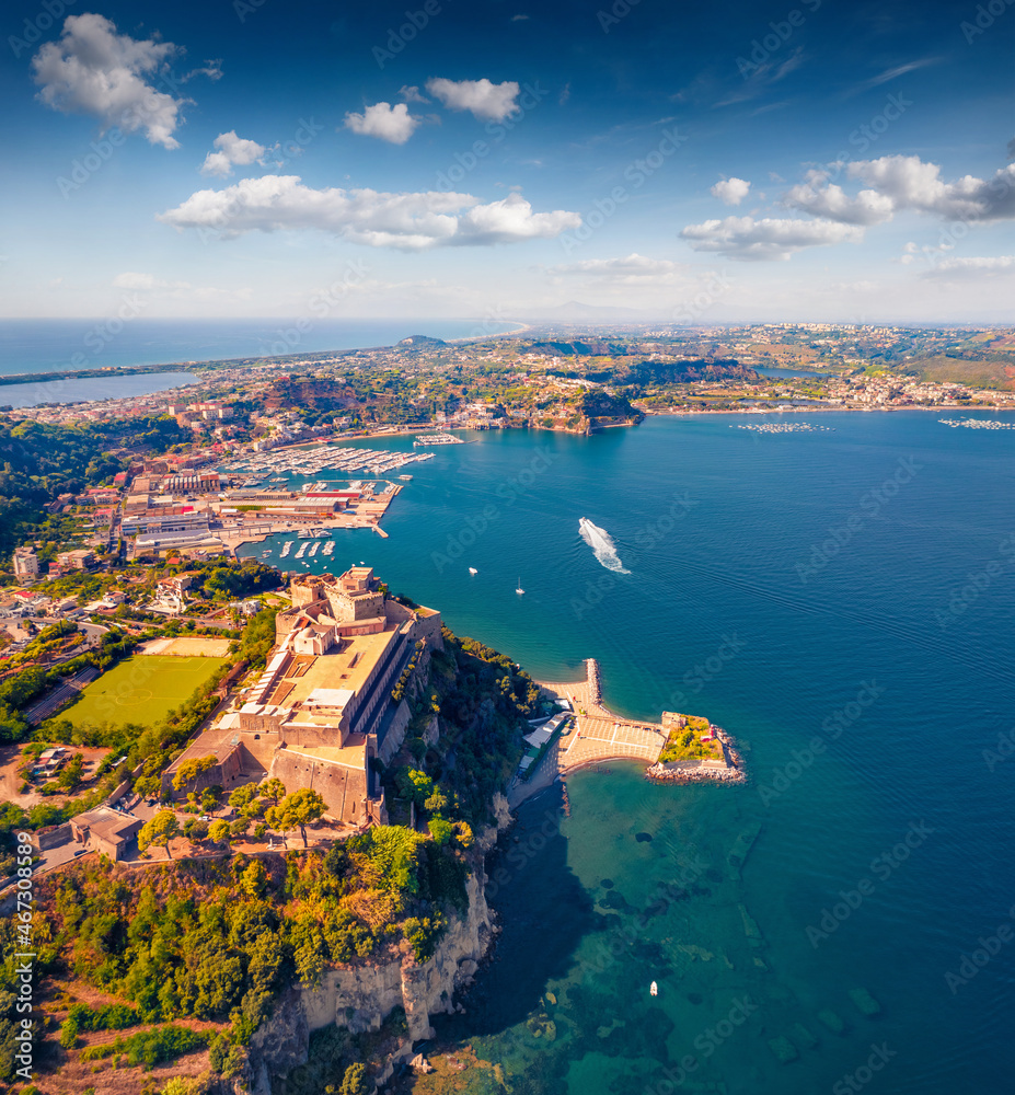 Captivating summer view from flying drone of Aragonese Castle of Baia, Italy, Europe. Beautiful morning seascape of Mediterranean sea. Traveling concept background.