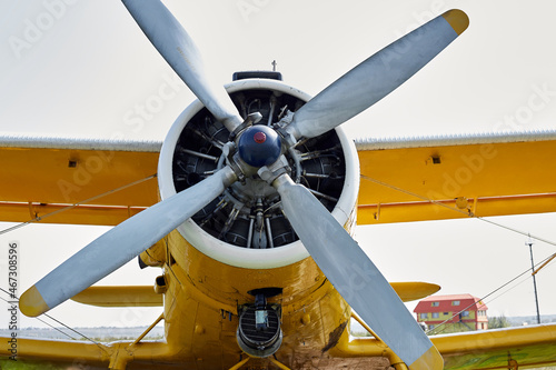 The propeller of the aircraft the yellow body of the car is on the ground ready for takeoff