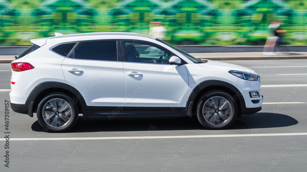White SUV car in motion. Hyundai Tucson 2019 model is driving on the ...