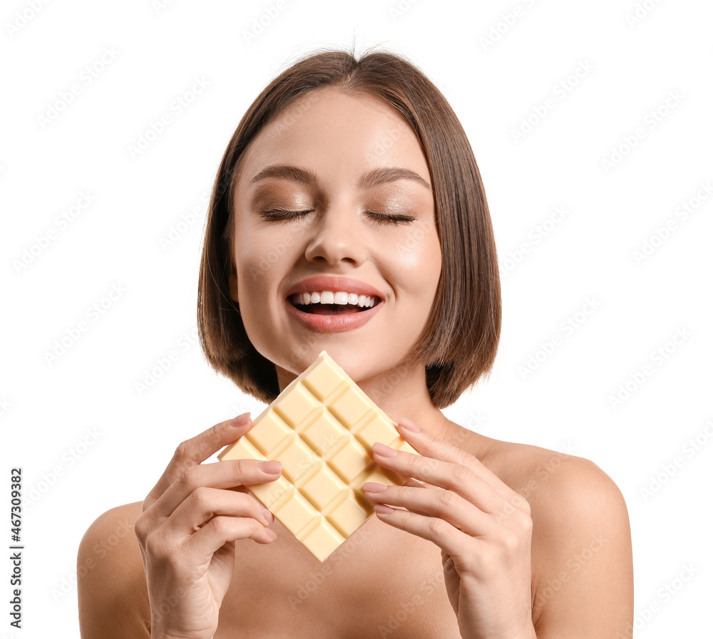 Beautiful young woman with sweet chocolate on white background