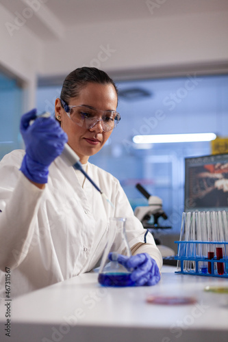 Fotografi Physician researcher dropping liquid in medical glassware using micropipette analyzing coronavirus vaccine expertise