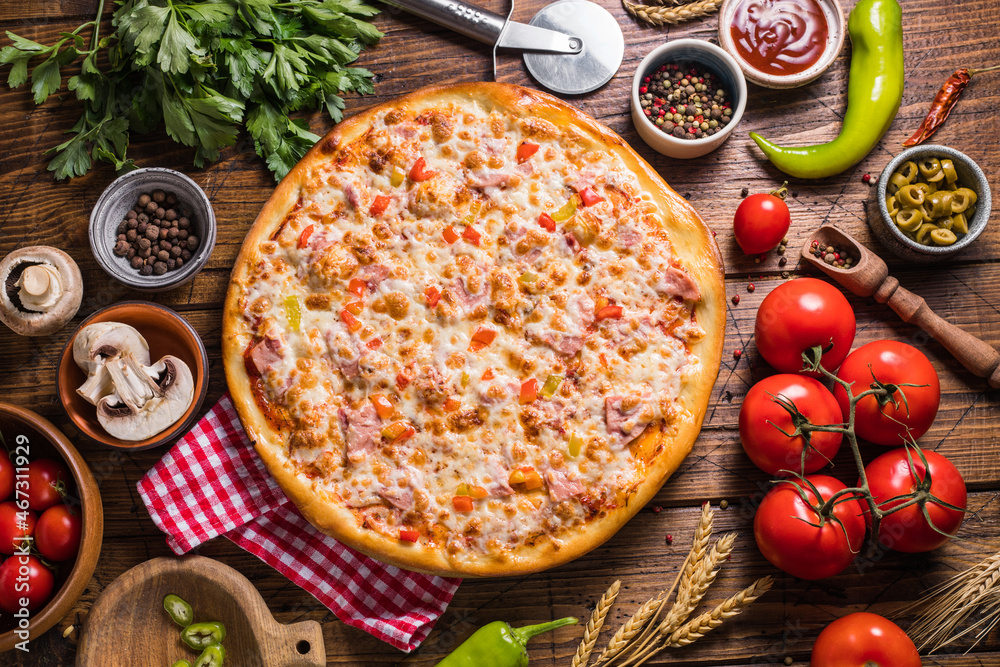 Homemade assorted pizza on a wooden table top view