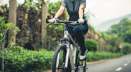 Riding a bike on tropical park trail photo