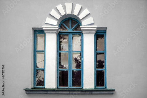 Various colors the Palladian window. Three-part window with a raised middle part, separated by decorative columns. Venetian window with wide arched center section with flat-headed lower side sections
