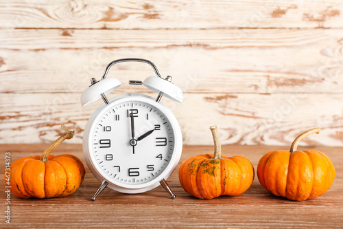 Alarm clock and pumpkins on...