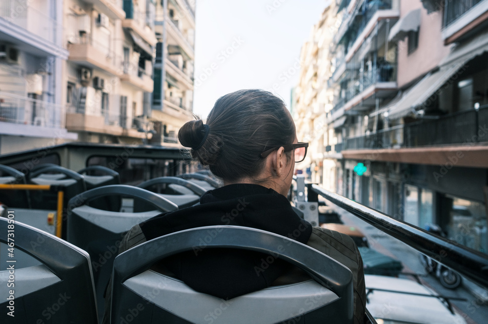 Back view at man on double-decker sightseeing bus in Thessaloniki, Greece