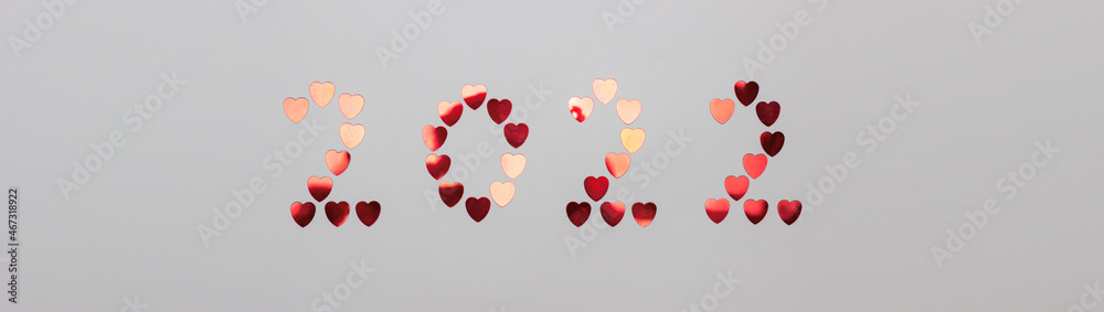 New year and christmas, valentine's day 2022. Inscription from shiny red hearts on a white background.