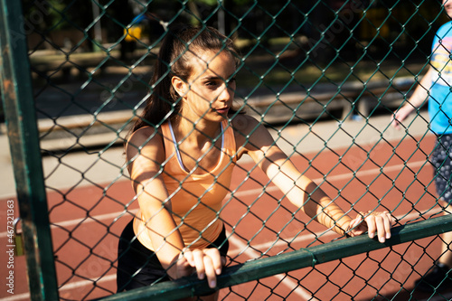Beautiful athlete woman in sportswear. Young woman preparing for the training outdoors © JustLife
