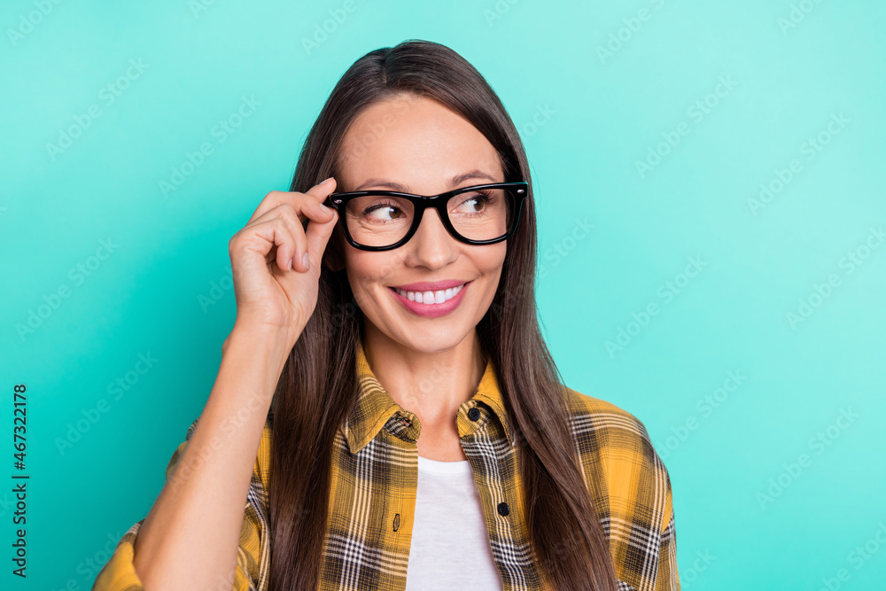 Photo of hr young brunette lady look empty space wear spectacles yellow shirt isolated on turquoise color background