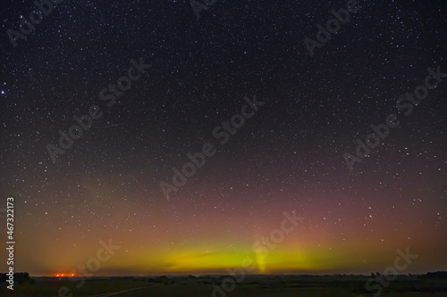 Milky way and Northern lights - Aurora borealis over the fields in Lithuania