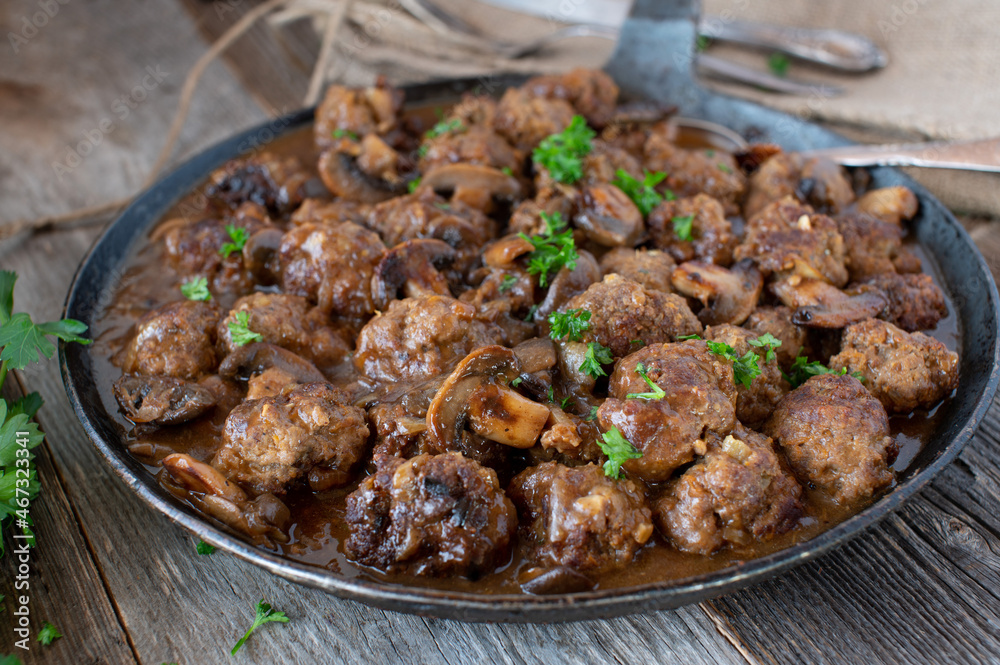 Meatballs with mushroom sauce in a rustic pan Meatballs with mushroom sauce in a rustic pan