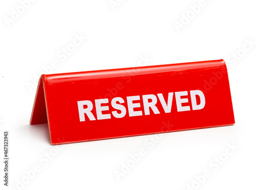 Red reserved sign isolated on white background. photo
