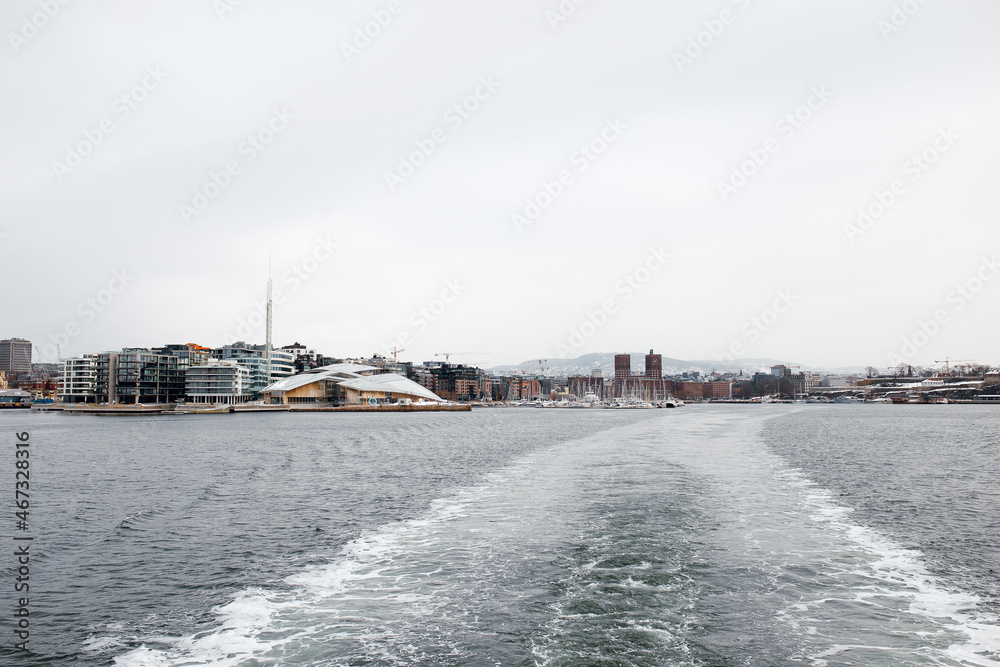 Beautiful view of the Oslo city from the ferry boat on the sea on winter day