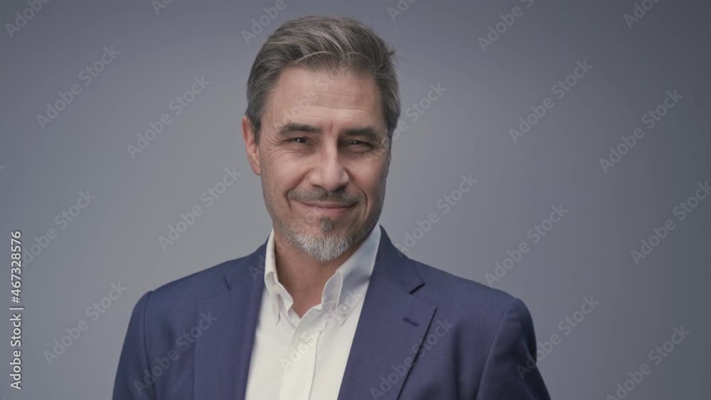 Business portrait - businessman smiling, jacket and open collar white shirt. Mature age, middle age, mid adult man in 50s with gray hair and happy confident smile. Copy space. Business portrait - businessman smiling, jacket and open collar white shirt. Mature age, middle age, mid adult man in 50s with gray hair and happy confident smile. Copy space.