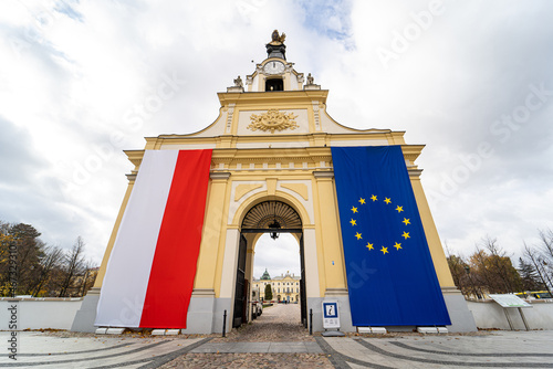 Polish and European Union flags on the entrance gate to the Branicki Palace in Bialystok, Poland. Poles defend EU membership fearing Polexit. Bialystok, Poland - October 22, 2021.