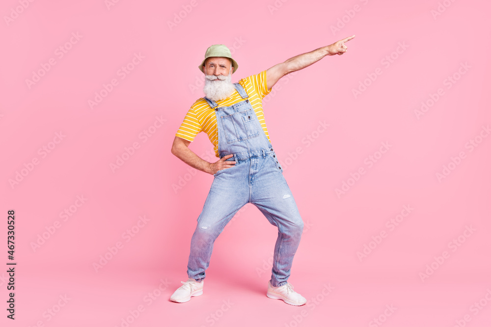 Full length body size view of attractive cheery funny man showing copy space isolated over pink pastel color background