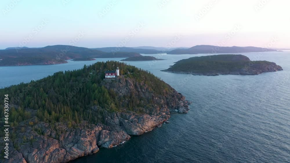 Isolated remote lighthouse on high cliff i dramatic coastal landscape in High Coast of Sween Isolated remote lighthouse on high cliff i dramatic coastal landscape in High Coast of Sween