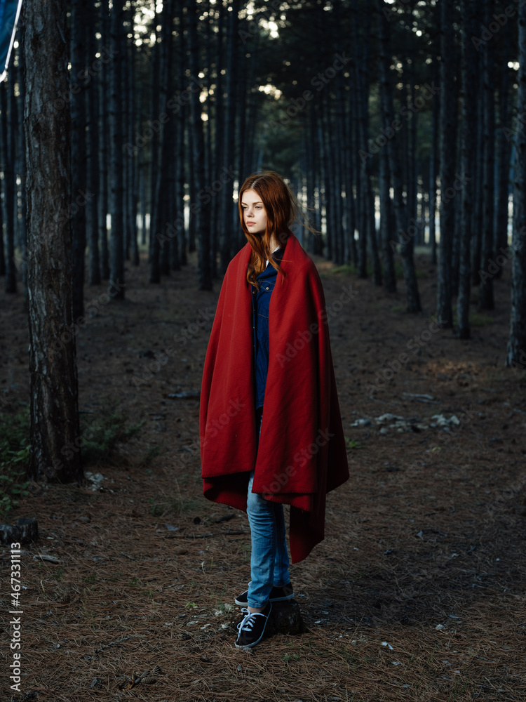 woman in the woods covered herself with a red blanket walk fresh air woman in the woods covered herself with a red blanket walk fresh air