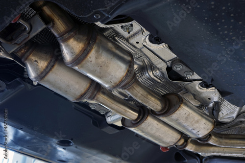 A catalytic converter (catalyst) installed on a modern car. Equipment for reducing harmful emissions into the atmosphere.