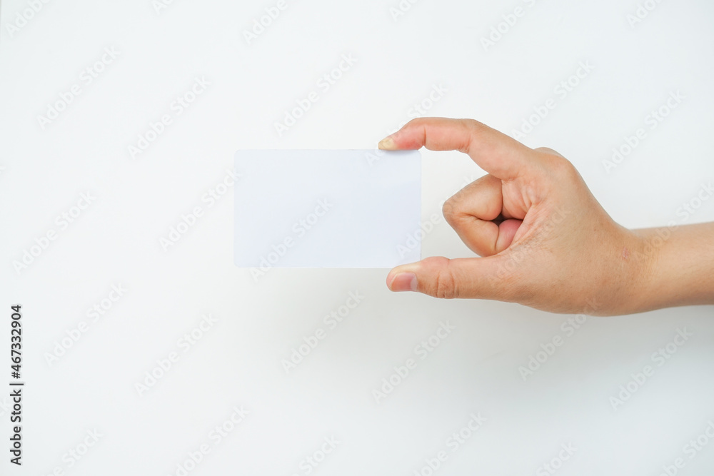 Obraz premium a right hand holds an empty white space on a white background. a card mockup that is suitable for business or identity mockup use.