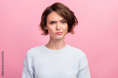 Photo of unhappy young woman bad mood irritated problem raise eyebrow isolated on pink color background photo