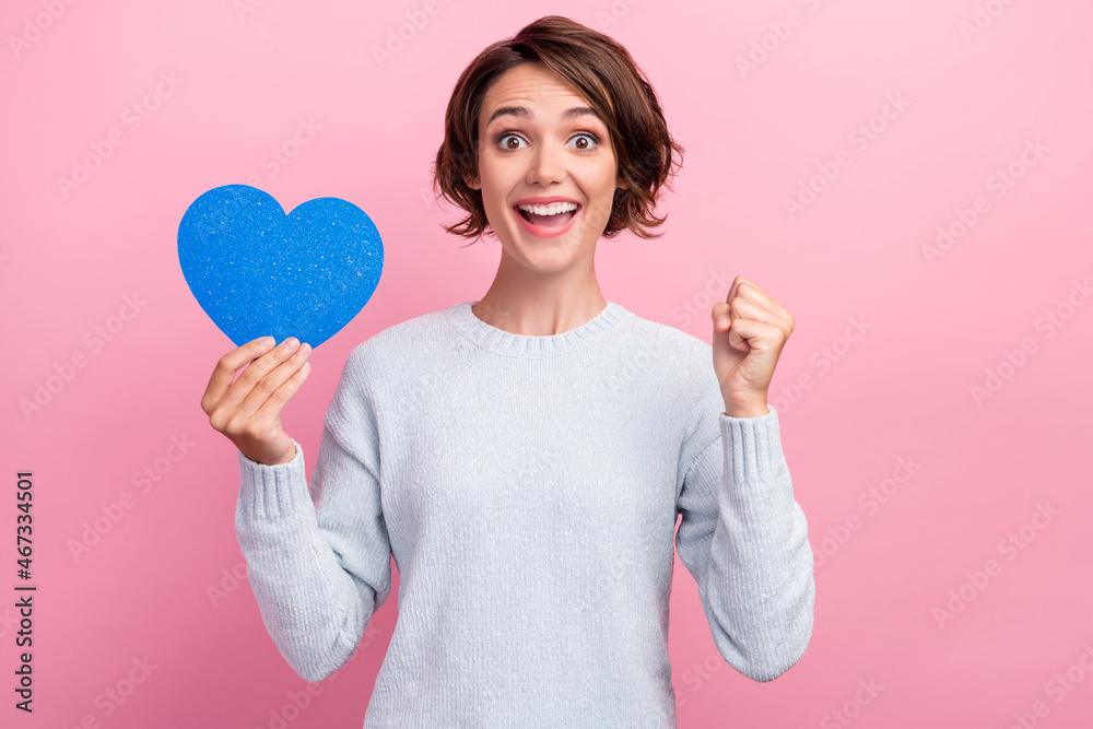 Photo of amazed happy woman hold paper heart winner smile luck feelings isolated on pink color background